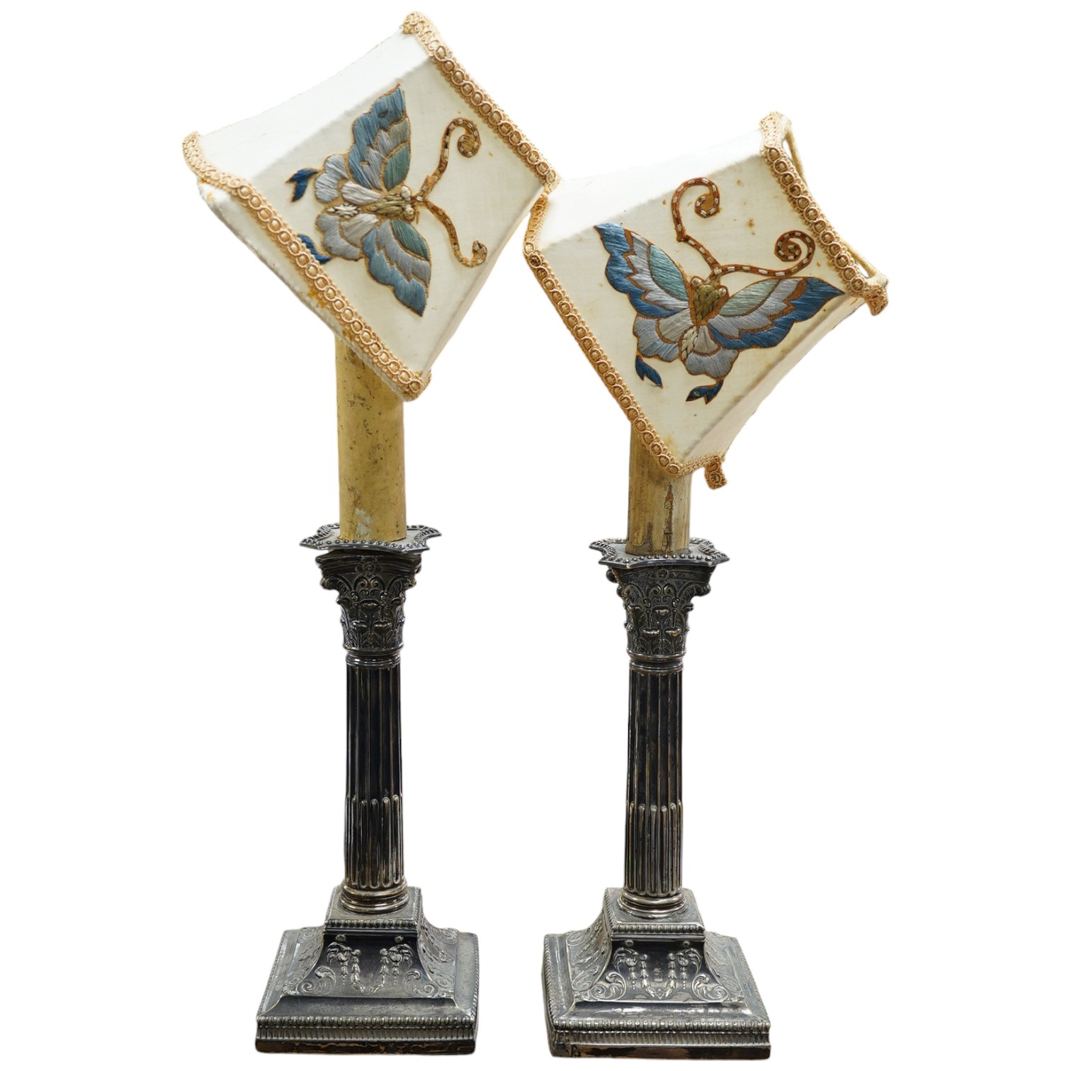 A pair of late Victorian silver Corinthian column candlesticks, now drilled for electricity and converted to lamps, James Dixon & Sons, Ltd, Sheffield, 1894, sticks only 21.8cm, weighted. Condition - poor